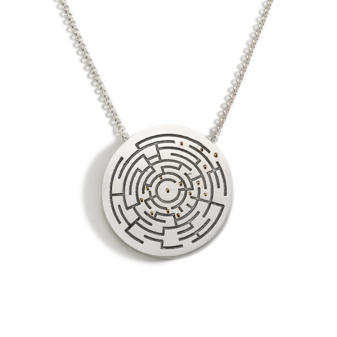 Circular silver statement pendant with an etched and oxidised maze and 18ct gold dots showing the way out